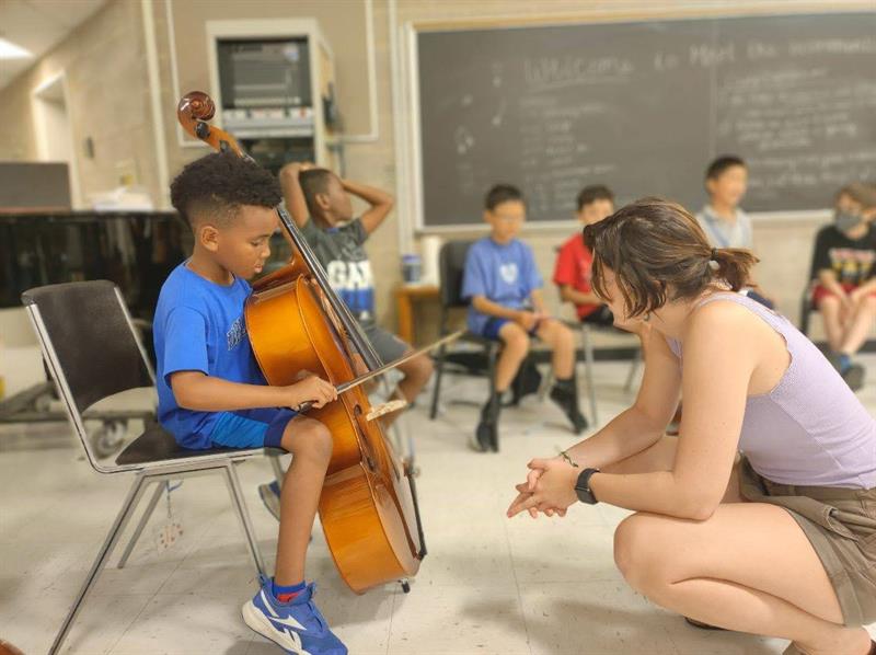 student with cello and teacher