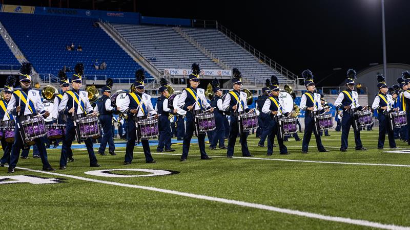 marching band members playing drums