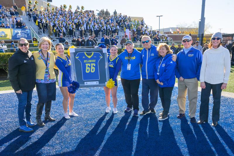 Sarver taking a picture with with UD President Dennis Assanis and UD First Lady Eleni Assanis, Director of Athletics Chrissi Rawak, Senior Associate​ Dean for the Arts Suzanne Burton and Director of the School of Music Mark Clodfelter