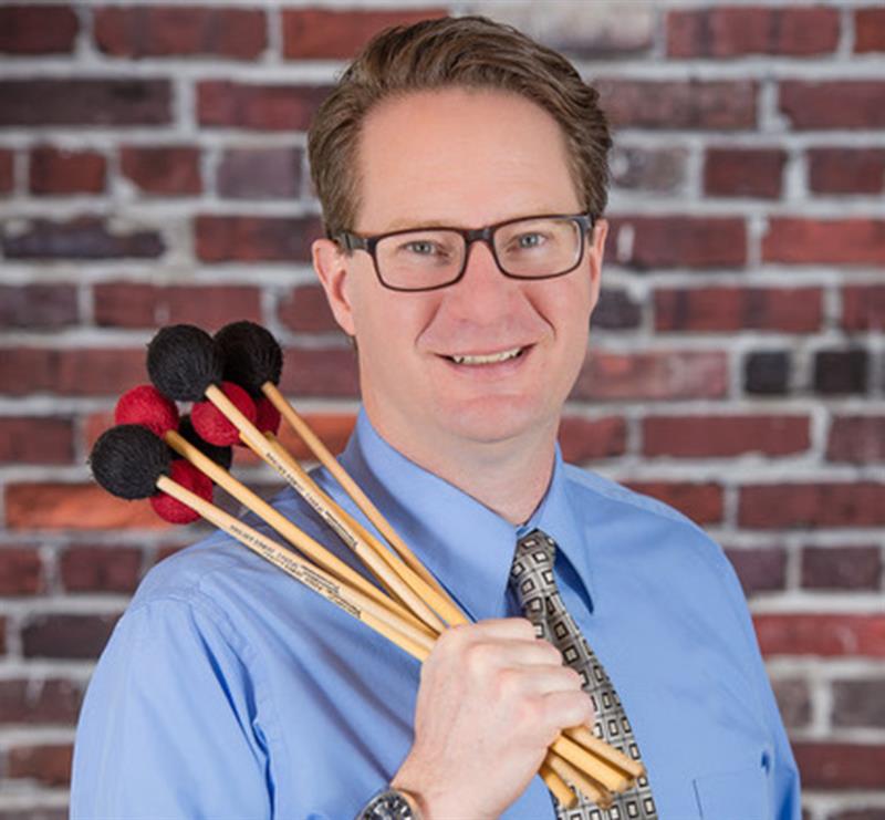 man holding percussion mallets