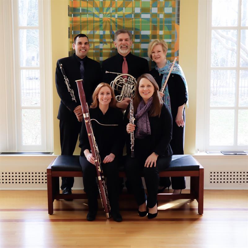 members of christiana winds holding instruments