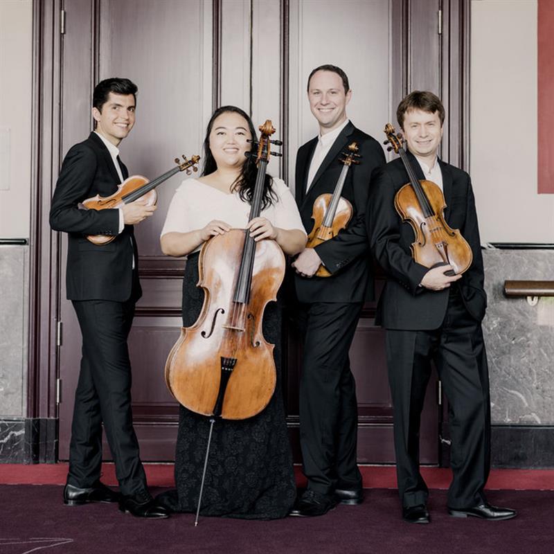 calidore string quartet holding instruments