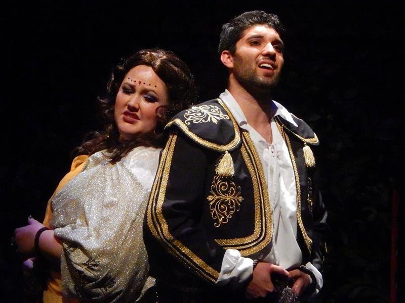 a woman and man singing opera