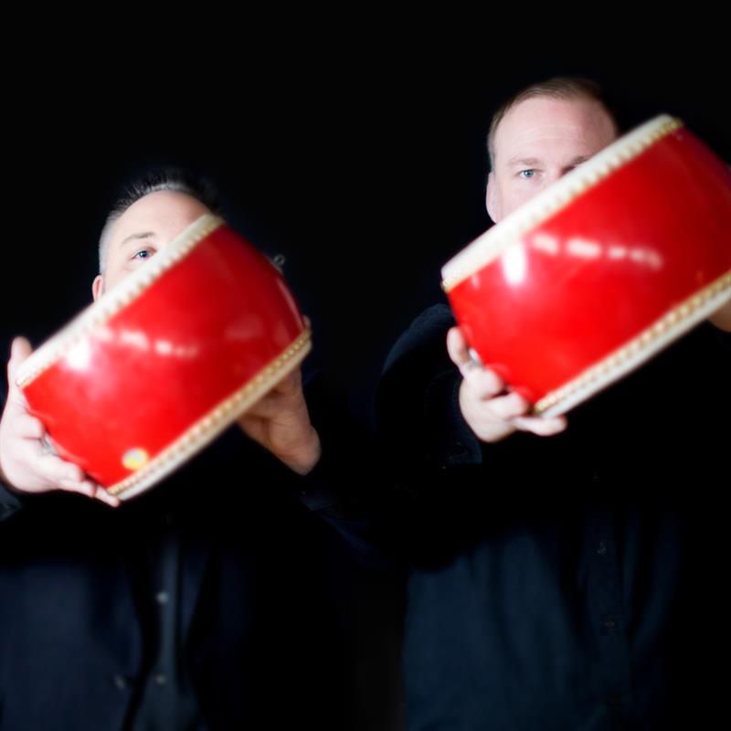 quey percussion duo holding drums